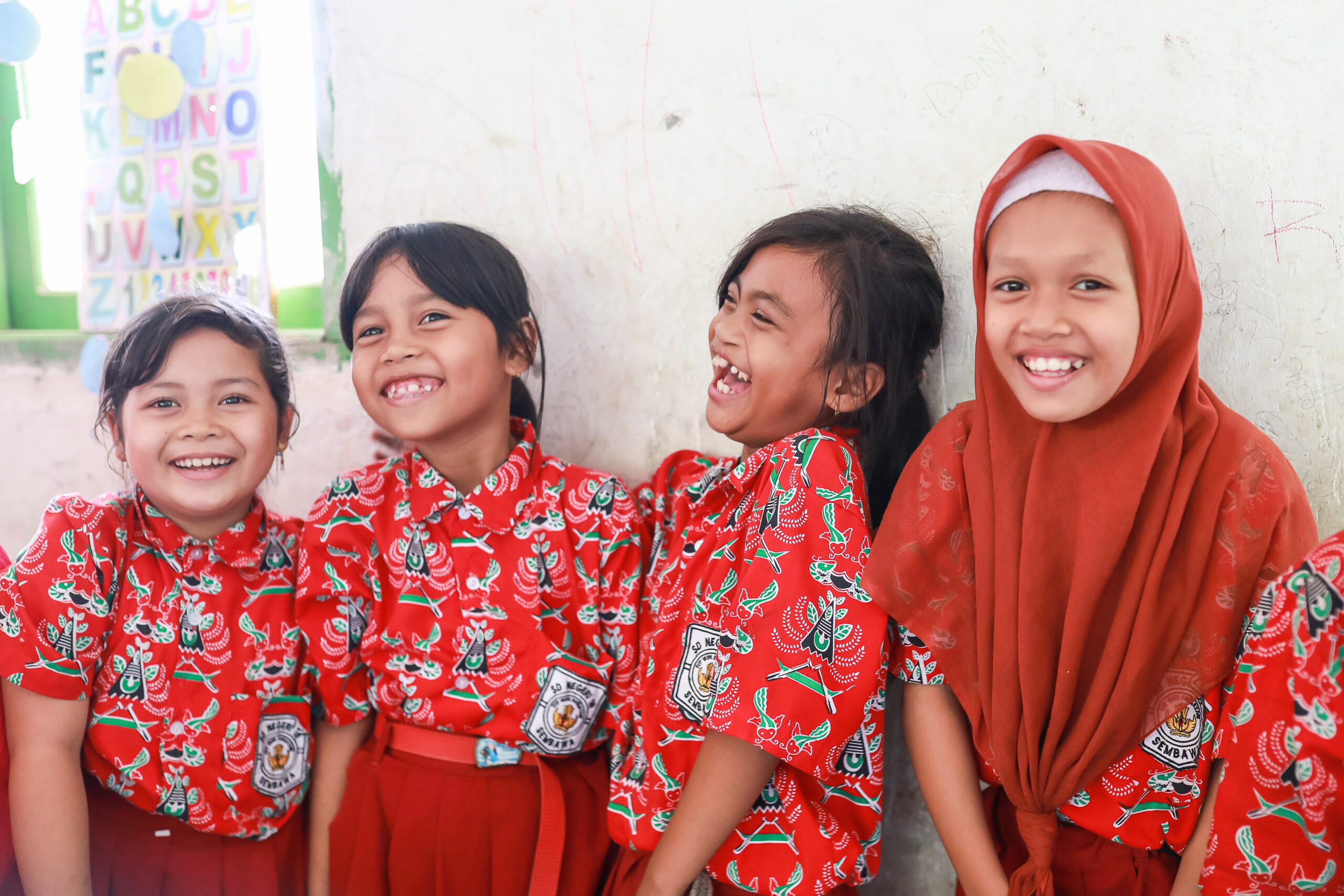 four girls smiling in classroom