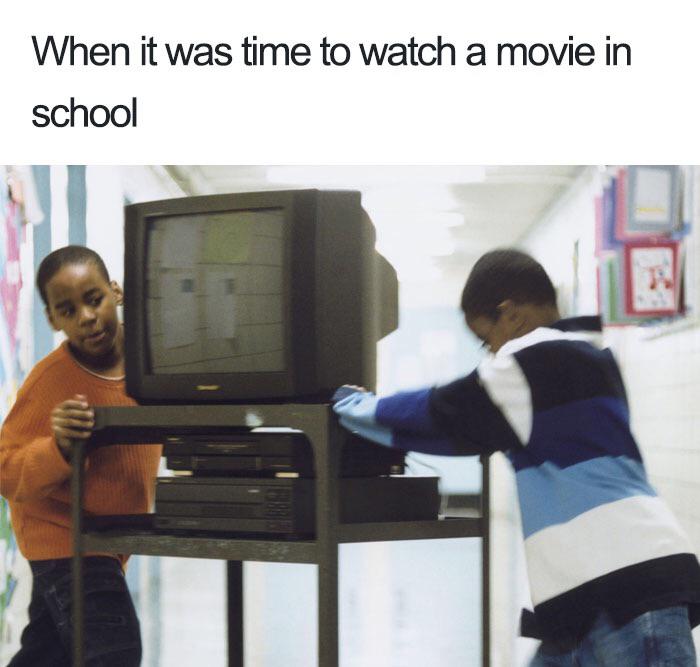 kids rolling tv cart into classroom labelled "when it was time to watch a movie in school"