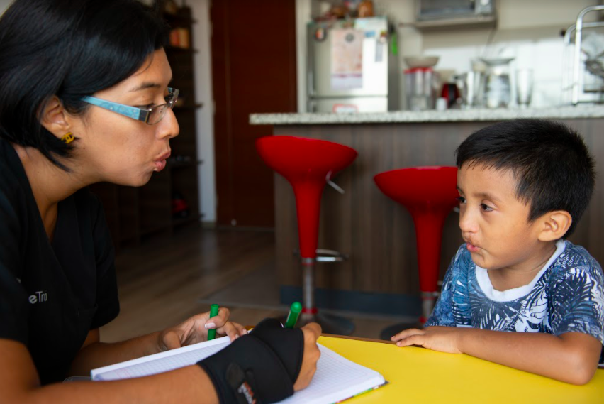 speech therapist working with little boy