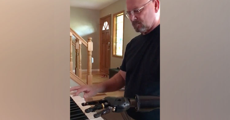 man playing piano with prosthetic arm