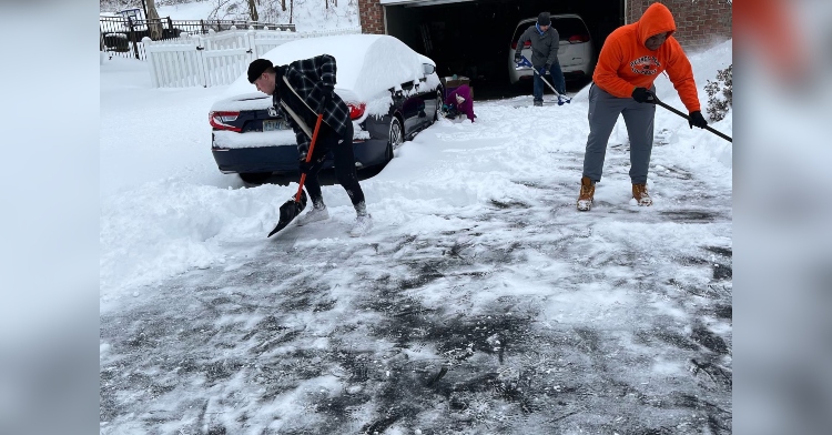 football team shoveling snow for neighbors