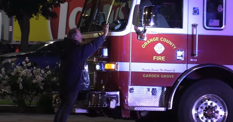 homeless man in front of fire truck