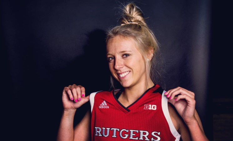 woman named kathleen fitzpatrick posing while showing off her rutgers basketball uniform 