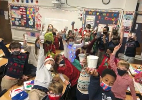 kathleen fitzpatrick's third grade holy trinity class holding up their hot chocolate cups