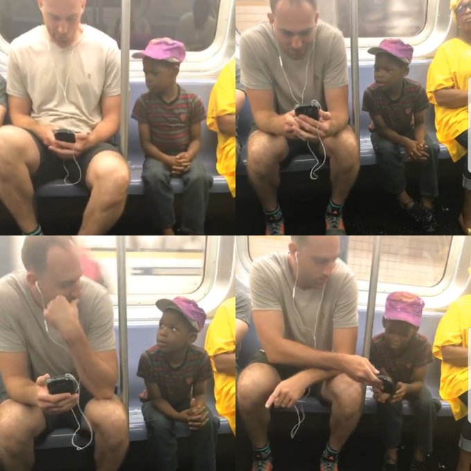man lets child play game on his phone on subway