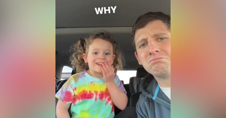 toddler named ellie looking shocked as she covers her mouth while her dad is making a frowny face