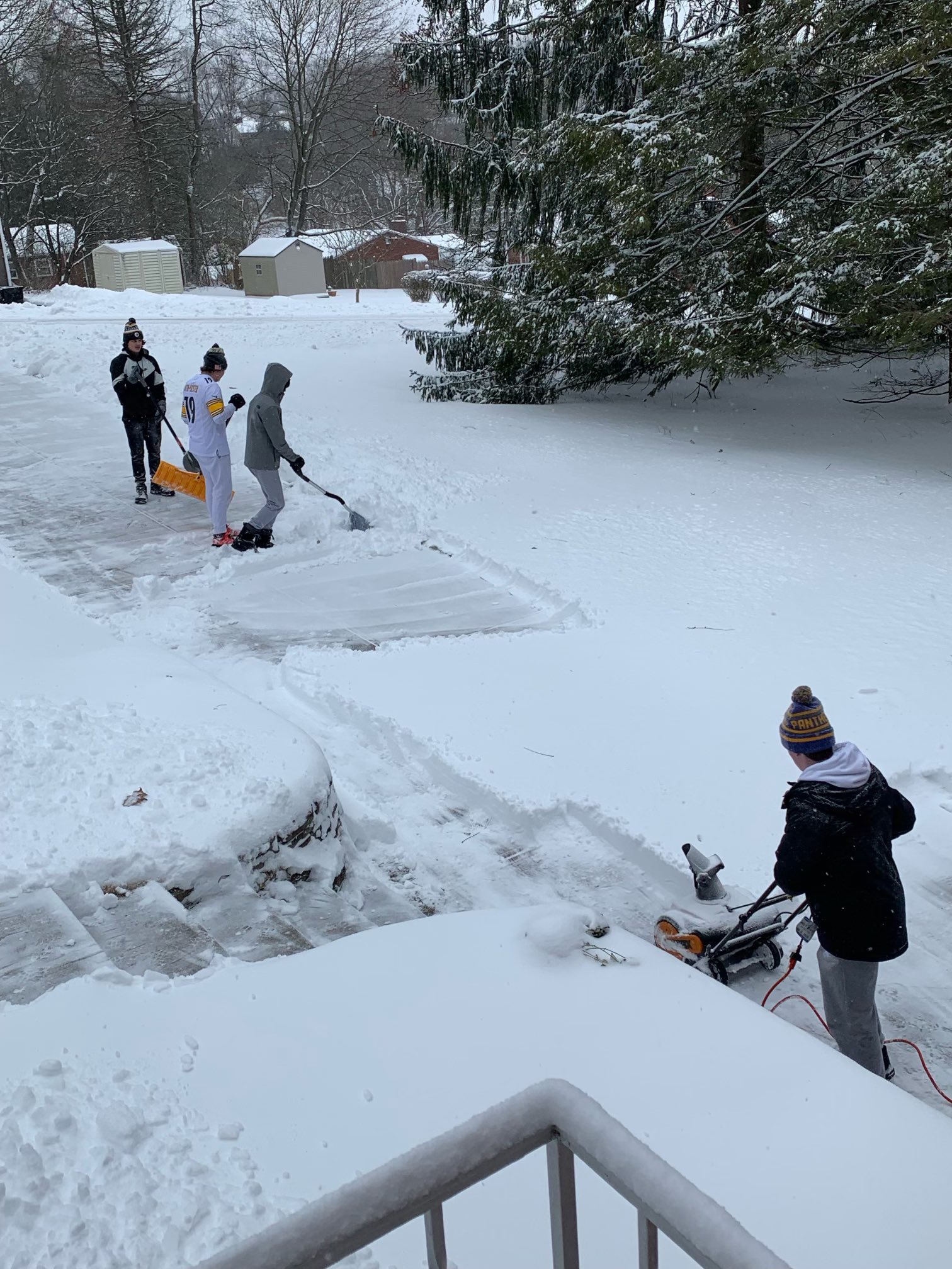 teens shoveling snow