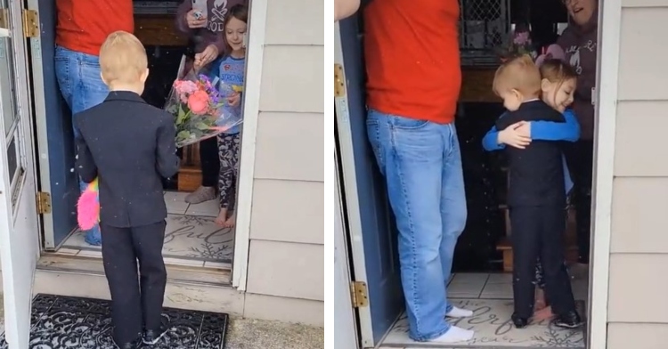 a 5 year old boy wearing a suit while holding flowers and a stuffed animal for another 5 year old, lyla, who is standing inside her house with her dad and those same five year old's hugging