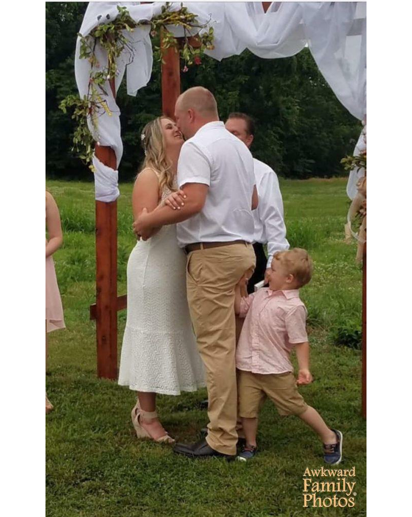 little boy whacking his dad's rear at the altar during wedding