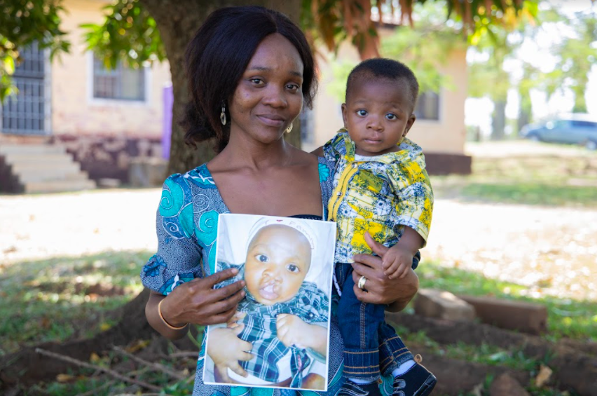 mom holding baby and picture of same baby with a cleft