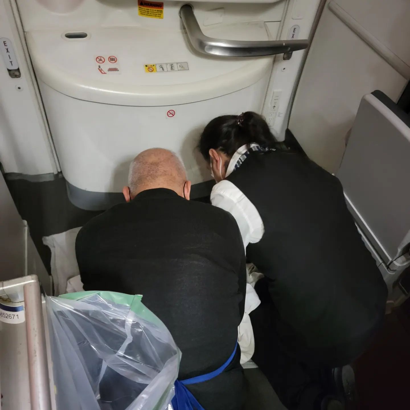 doctor and nurse helping woman have a baby on a plane