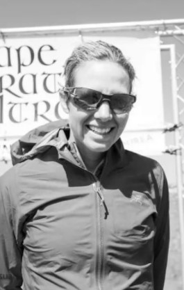 a black and white photo of a woman named pam harght wearing sunglasses as she smiles and poses outside 