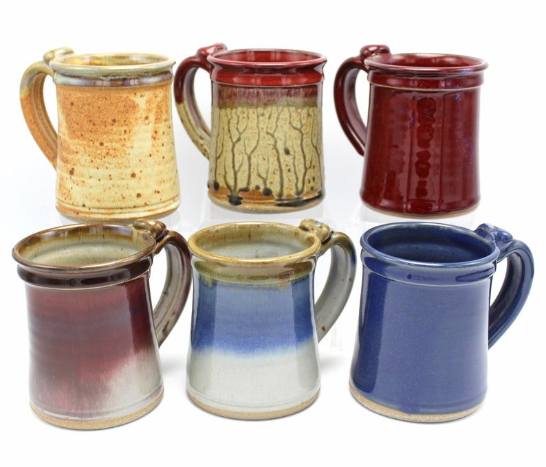 six handmade pottery mugs in various colors and patterns by etsy user earthenfirepottery