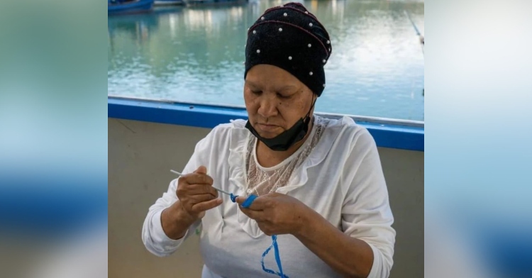 a woman named jane hoffman crocheting using plastic as part of the group rebag.reuse in south africa