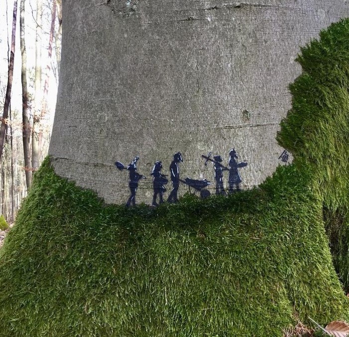 graffiti art art by jsp of miniature shadows of people on a tree that are walking on moss in a line 