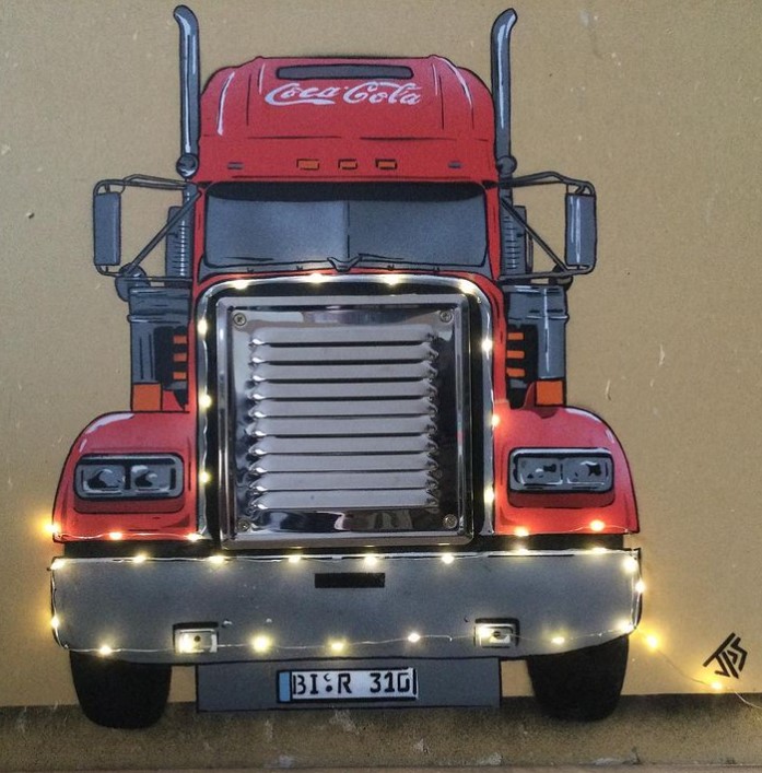 graffiti art by jps of a giant coca-cola truck decorated with real fairy lights