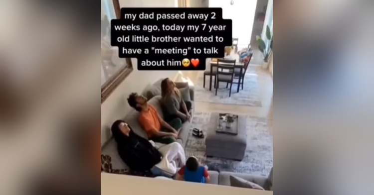 a 7 year old boy and his three older siblings sitting in a living room looking up toward the ceiling to talk to their dad who recently passed away