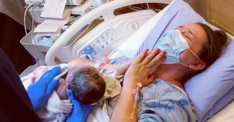 erin blaskie closing her eyes as she cries tears of joy as she's being handed her newborn.