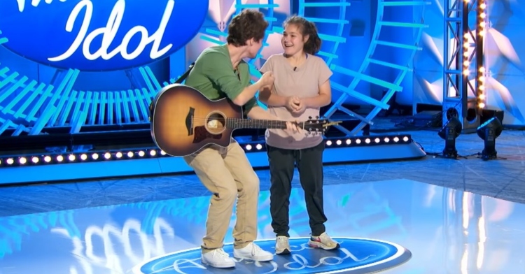 a man named cole hallman playing a guitar and singing with his little sister, katie, while auditioning for american idol