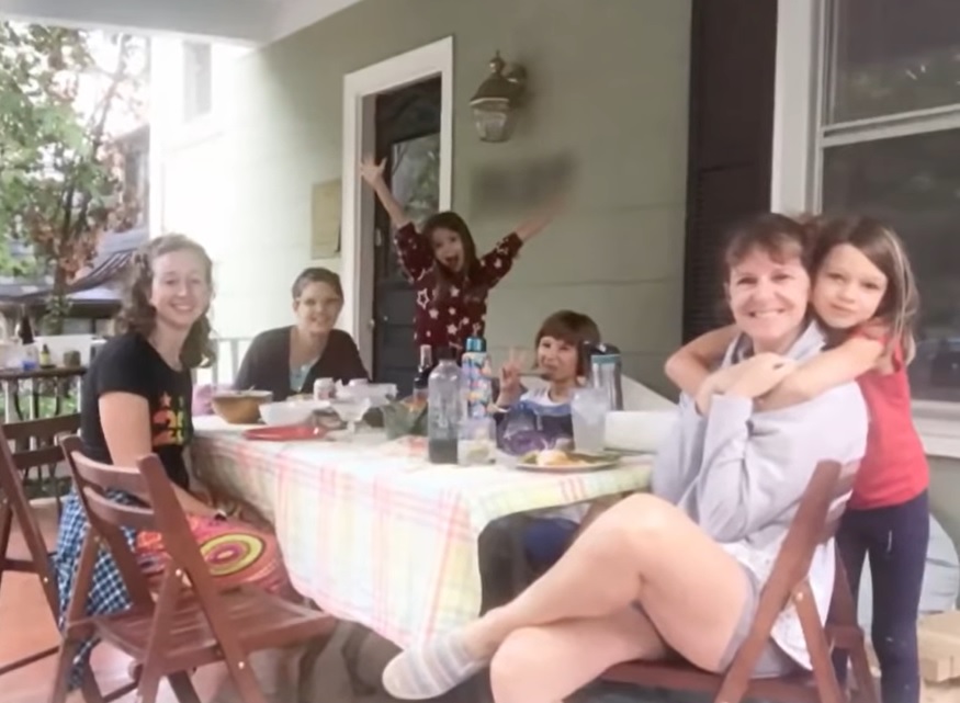 Siren house residents sitting around a rectangular table