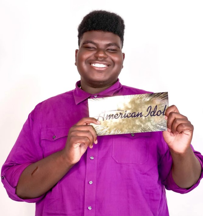 18-year-old douglas mills smiling as he shows off his golden "american idol ticket that gets him to hollywood, the next round of the competition 