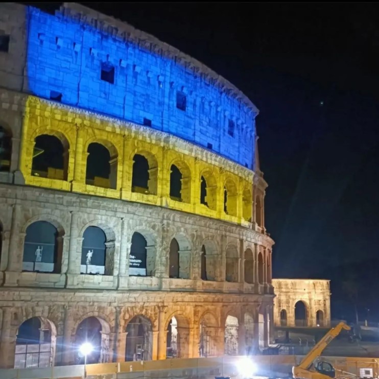 a building in rome that is lit up with the colors of the ukrainian flag in a show of solidarity 