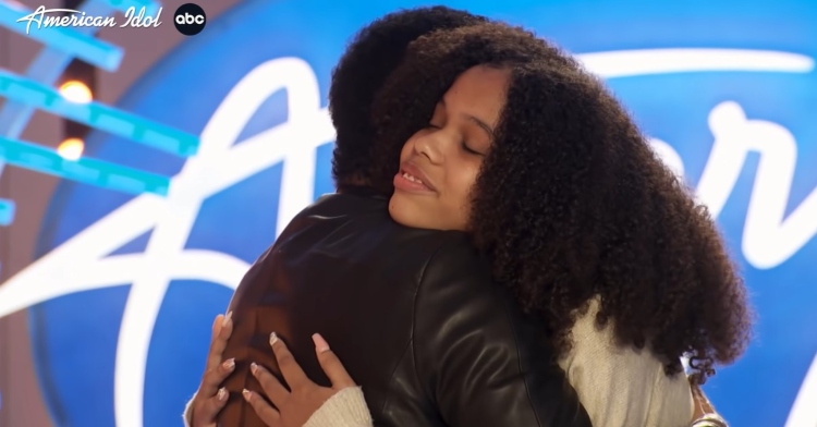 closeup of grace franklin, who is aretha franklin’s granddaughter, hugging lionel richie after her american idol audition