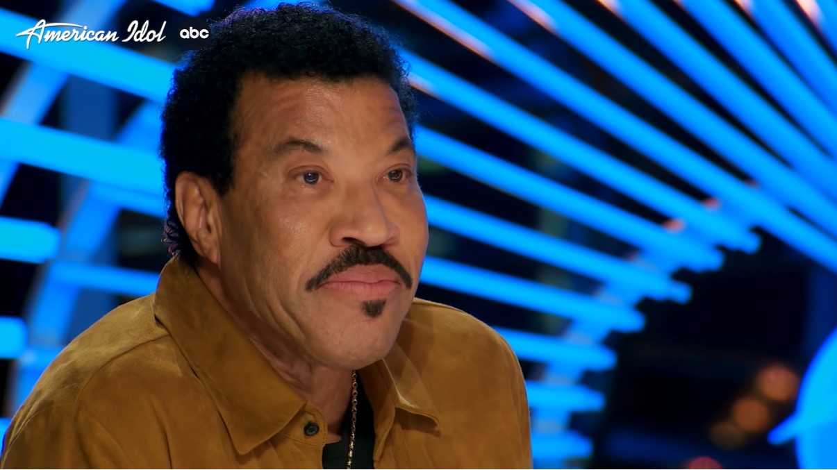 closeup of lionel richie smiling as he talks to kelsie dolin, a contestant on american idol who just finished her audition 