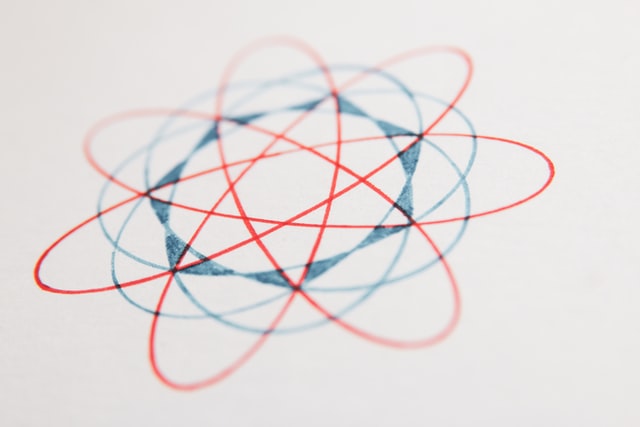 closeup of a red and blue design made with a spirograph