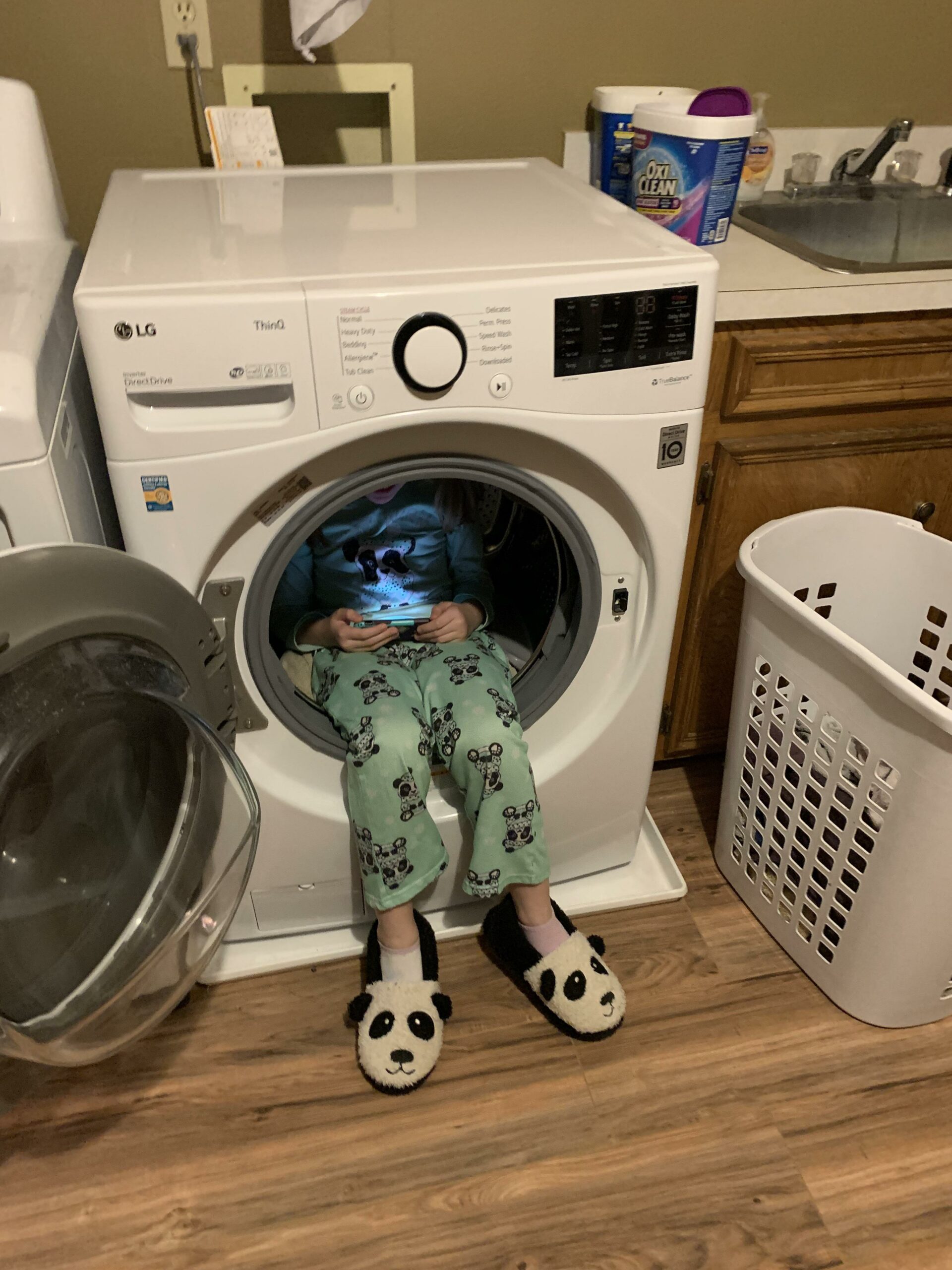 kid sitting inside clothes dryer