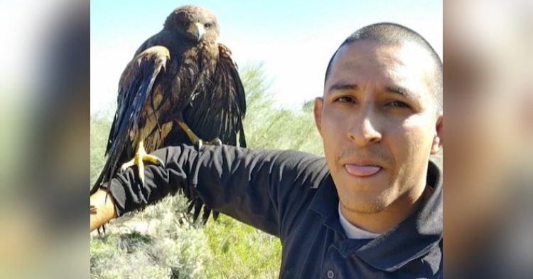 a man named steven gonzales taking a selfie with the hawk he saved from a pool standing on his arm