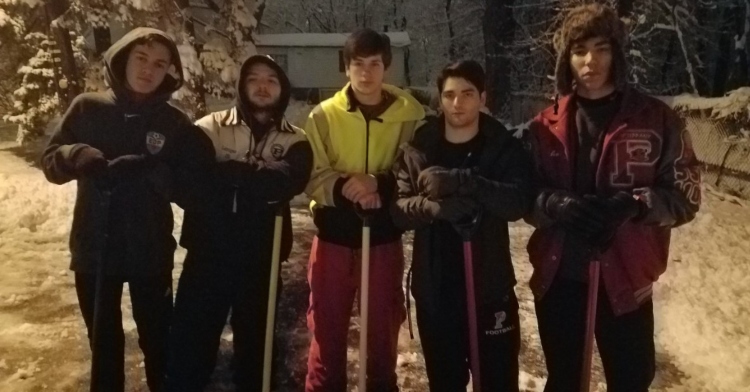 five teenage boys named justin, patrick, chris, tyler, and amos posing with snow shovels outside after shoveling an elderly woman’s driveway