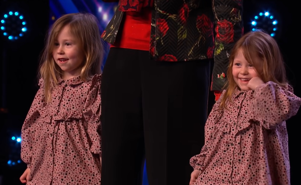 nick edwards' daughters standing on the bgt stage with their grandma.
