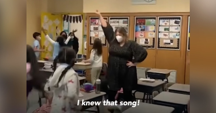 assistant principal heather sosnovsky dancing with her students in a classroom. there is a caption that reads “I knew that song!”