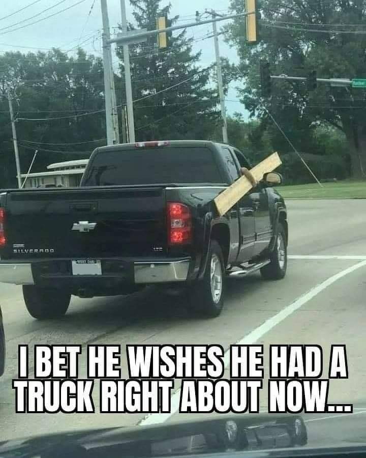 man holding board outside of truck window