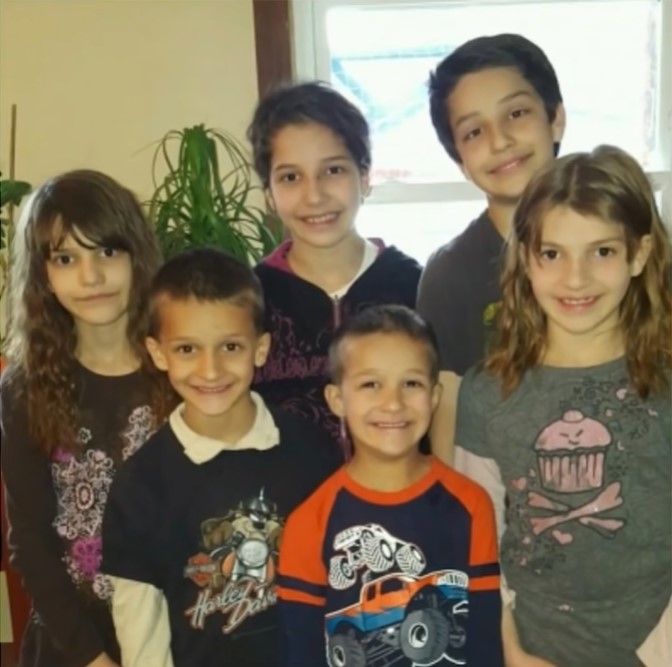 the first photo of carlos, guadalupe, maria, selena, nasa, and max that steve and rob anderson-mclean ever saw of their future adopted children.