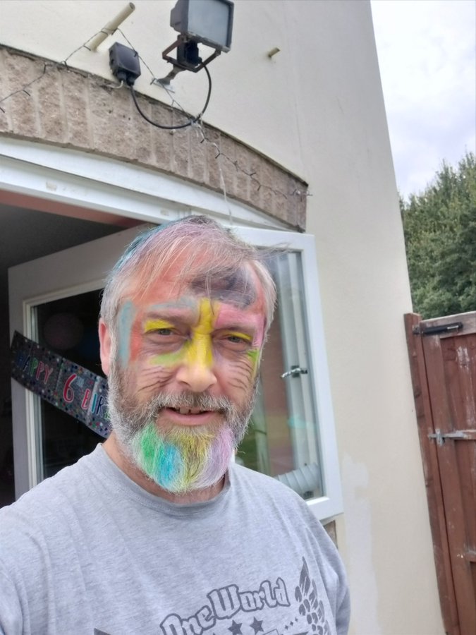 dad with many different colors on his face.
