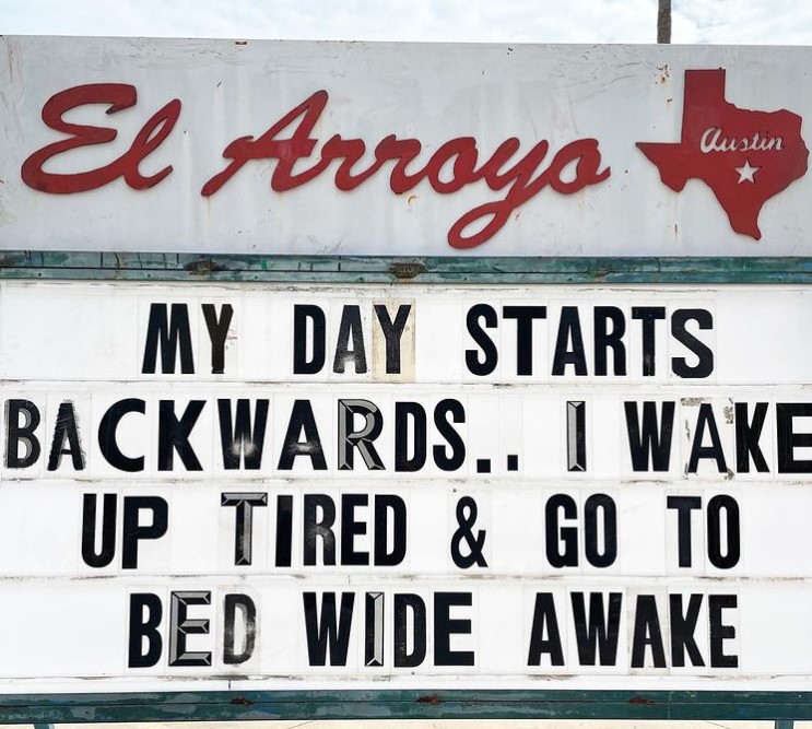 el arroyo marquee that reads "my day starts backwards.. I wake up tired & go to bed wide awake."