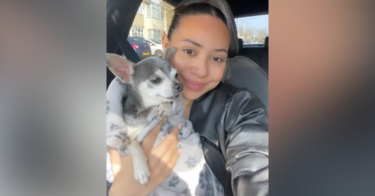 22-year-old tae bennet smiling as she holds her now 12-year-old dog, ollie, for the first time since he went missing a decade ago.