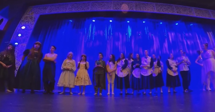the students of early light academy on stage for their performance of "frozen."