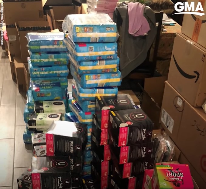 stacks of pads and tampons next to stacks of amazon boxes. these were delivered to eighth grade teacher kylie defrance's house.