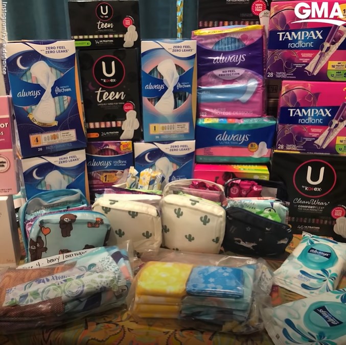 a table stacked full of pads, tampons, and other feminine hygiene products.