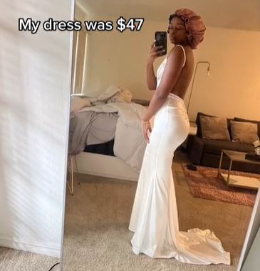 woman taking a mirror selfie with her wedding dress