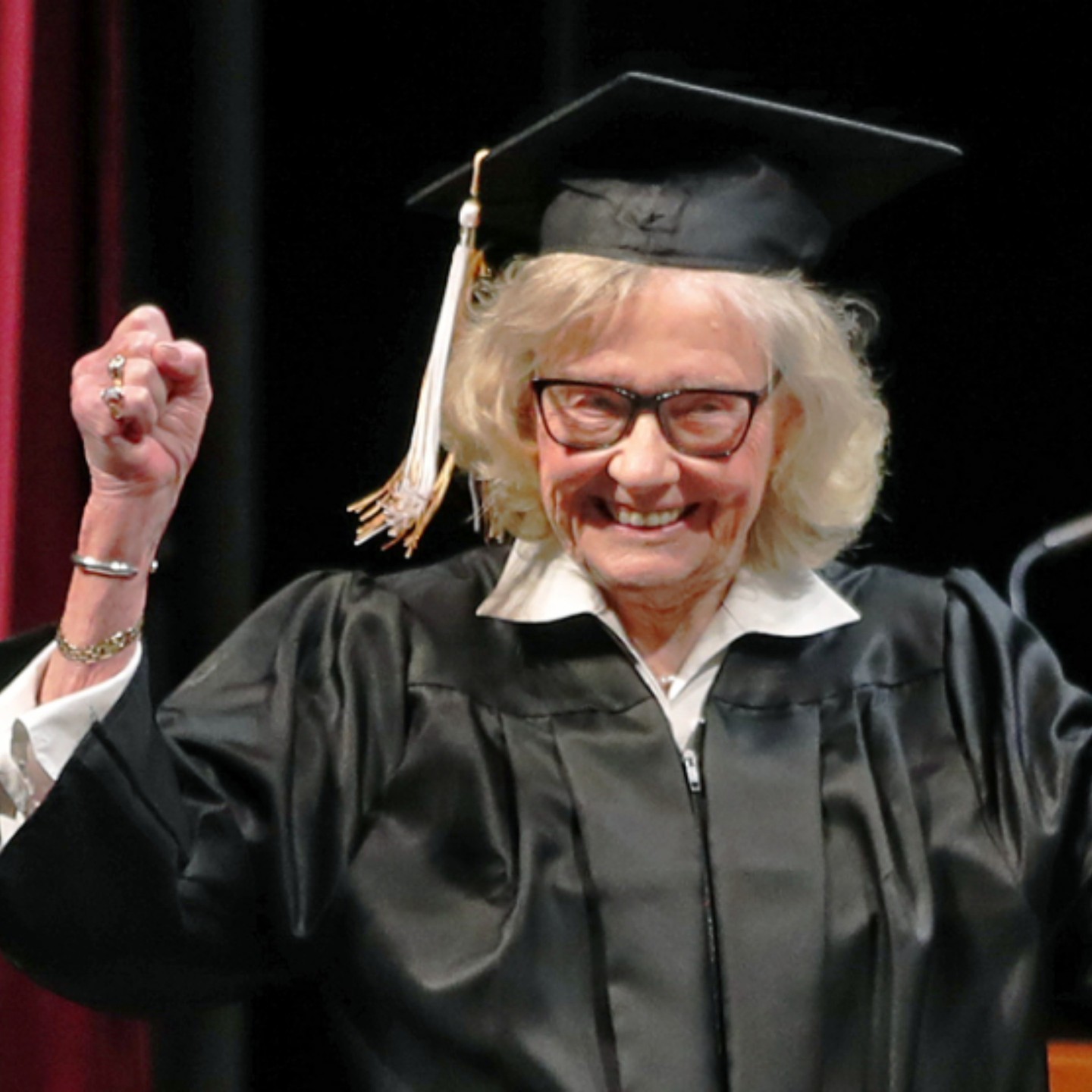 Betty Sandison smiling with her graduation gown at 84 years old