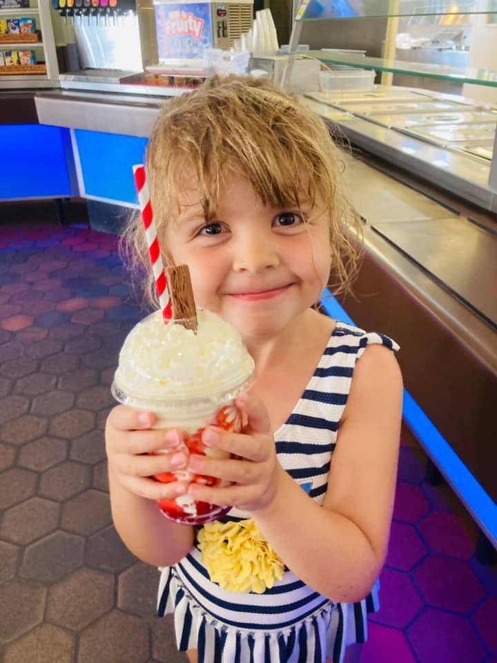 Evie-Mae Geurts smiling and holding a milkshake