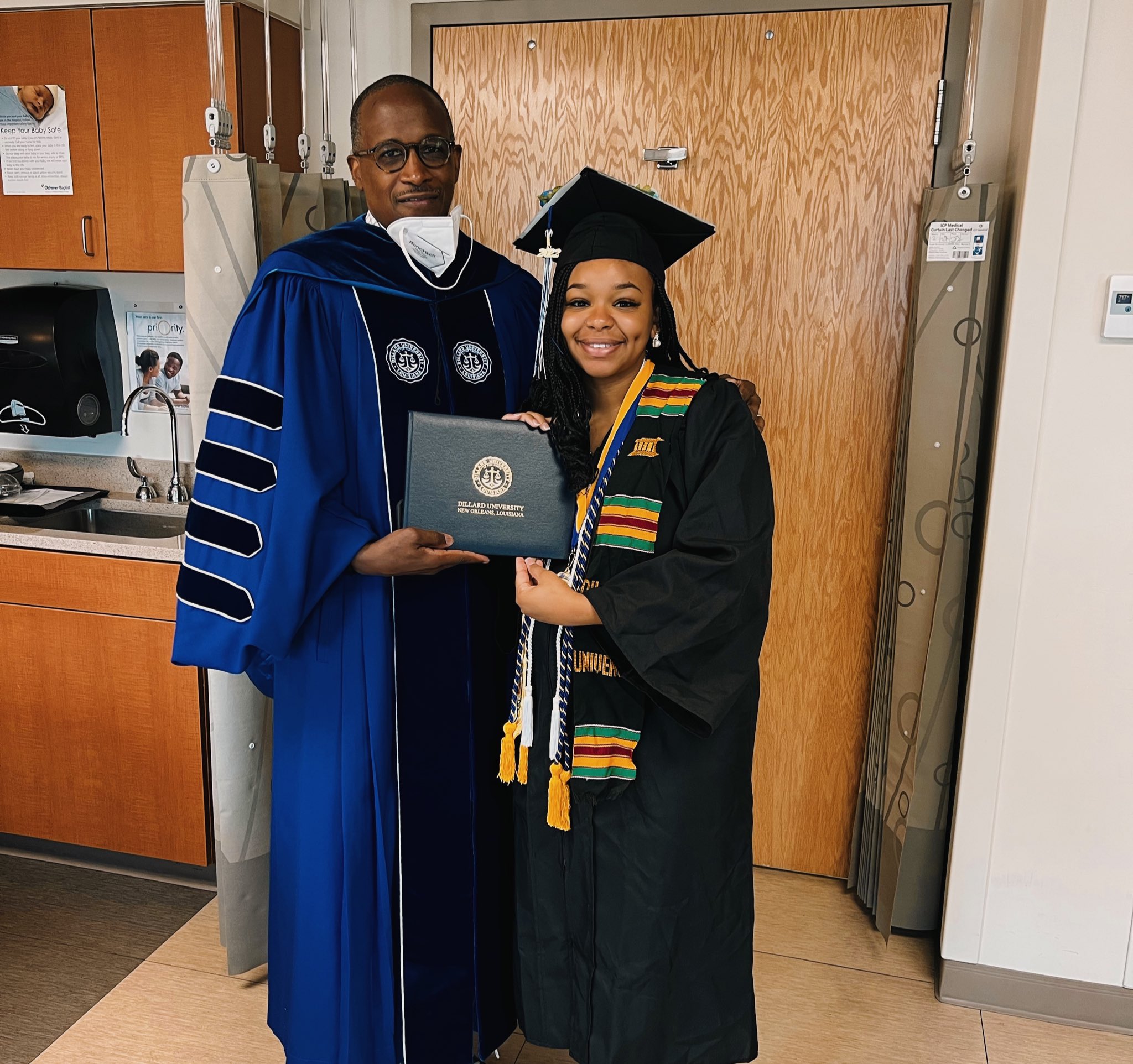 Jada Sayles and her university's president holding her degree