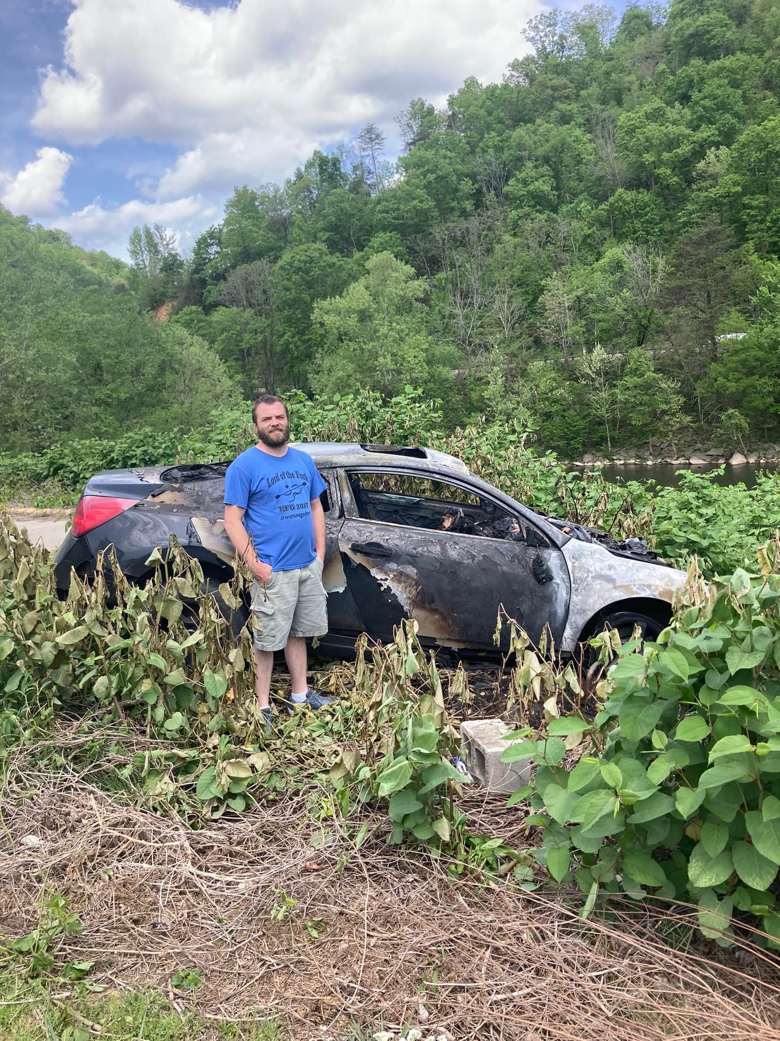 justin quesenberry standing next to a car that caught on fire and is not burned.