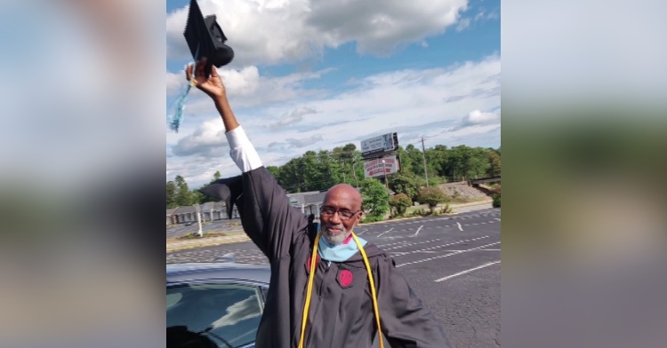 Leroy Harley raising his graduation cap