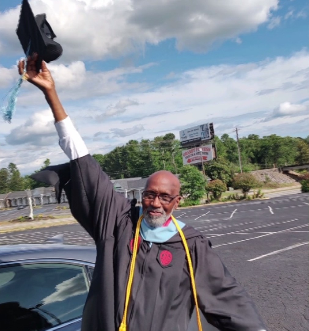 Leroy Harley raising his graduation cap
