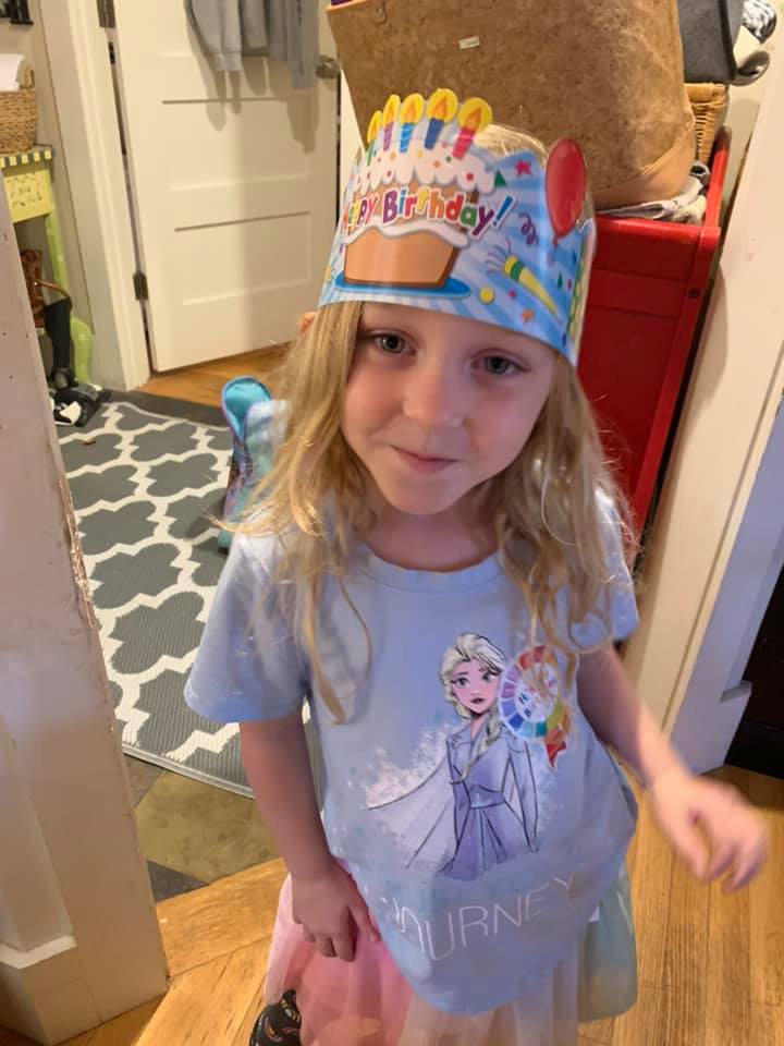 macie semrau smiling in an elsa top and cardboard birthday crown.
